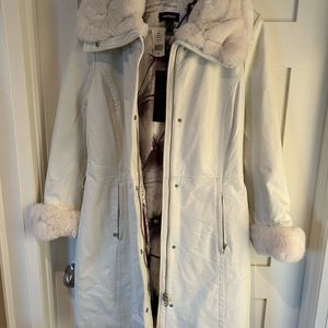 White leather jacket with rabbit fur trim.